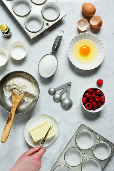 Hand Cutting Butter While Baking Raspberry Muffins or Cupcakes — Stock Photo, Image