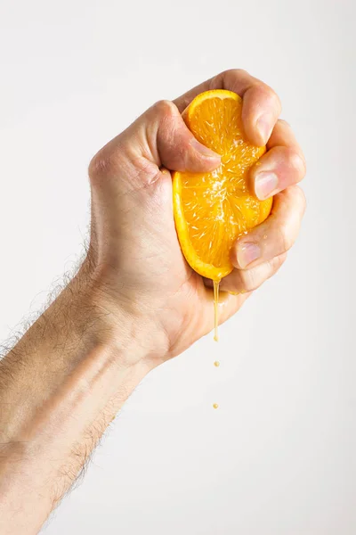 Man's Hand Squeezing an Orange — Stock Photo, Image