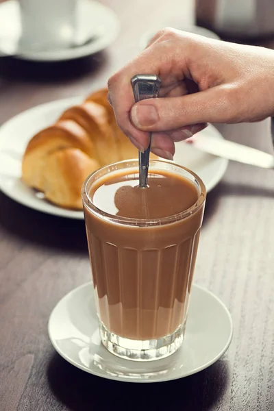 Rühren eines portugiesischen Café Latte (Galao) in einem Café — Stockfoto