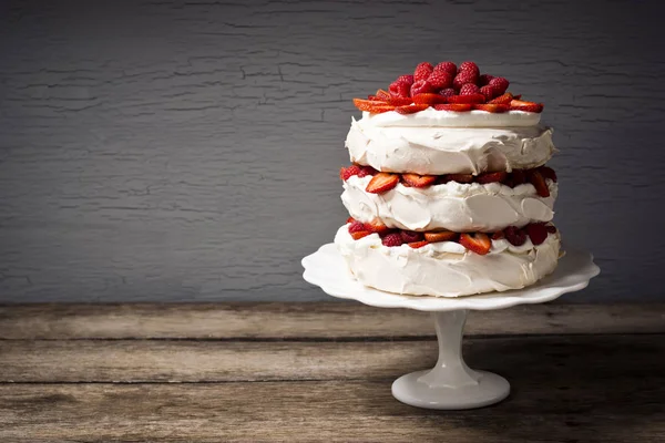 Layered Pavlova Meringue Cake with Berries on Cakestand