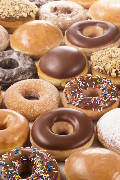 Background of Different Types and Flavors of Donuts (Doughnuts) — Stock Photo, Image