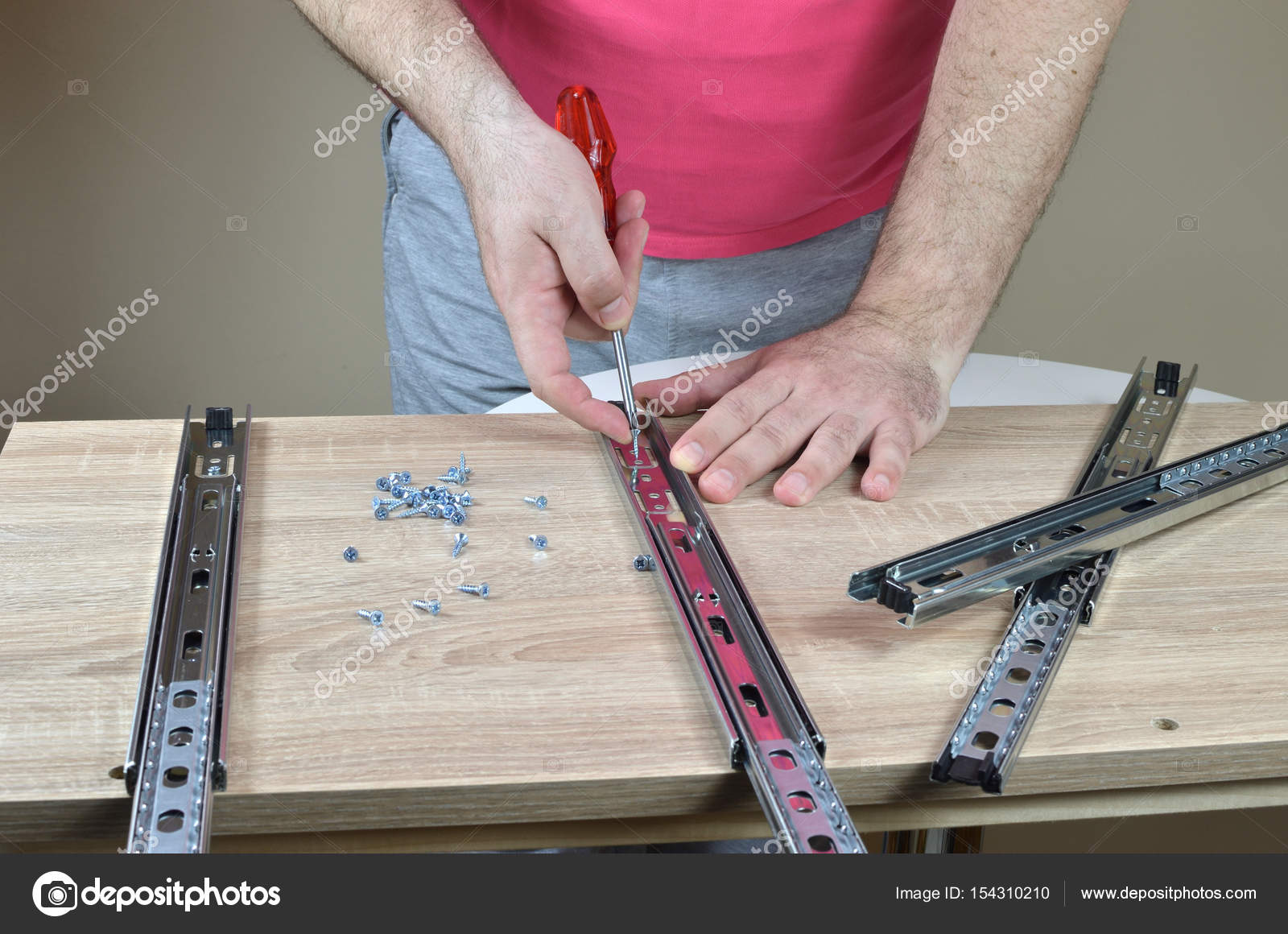 Installing A Drawer Slides On A Cabinet Stock Photo C Bane M