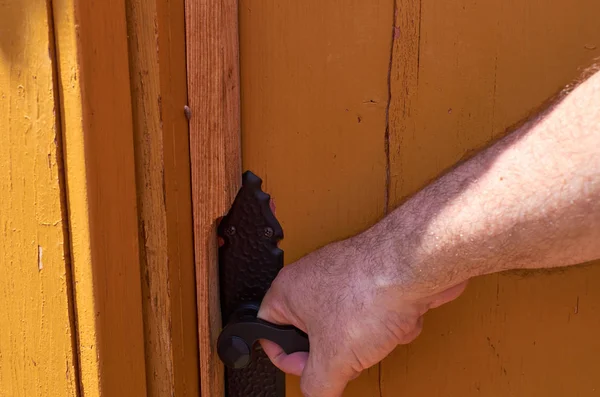 Hand holding a door handle
