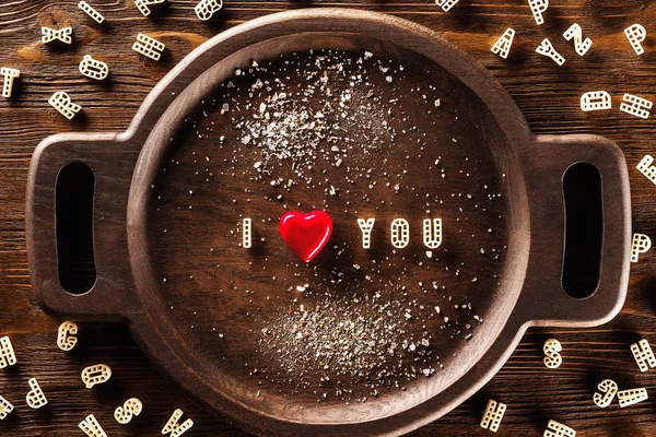Words I love you made of macaroni letters and red heart at vinta