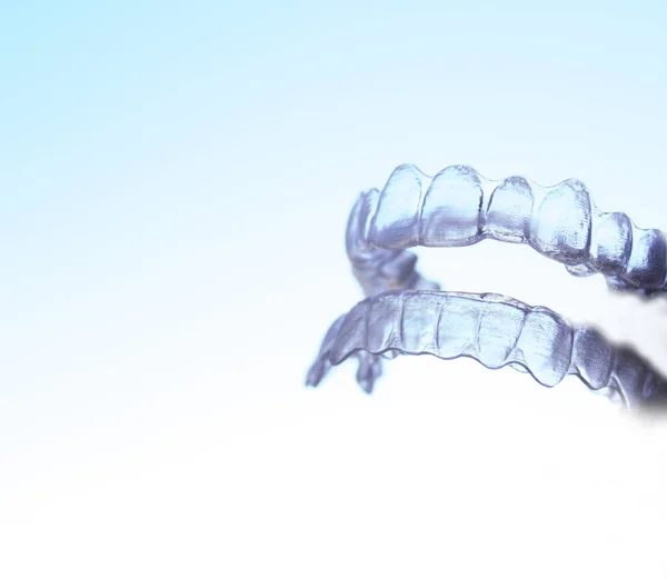 Invisible dental orthodontics held by a woman — Stock Photo, Image