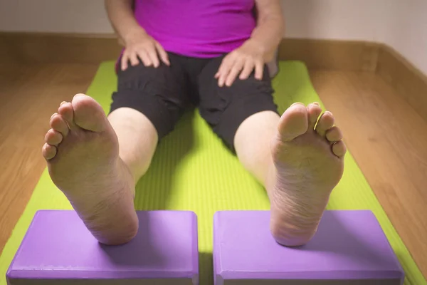 Rehabilitation exercises with yoga blocks for seniors