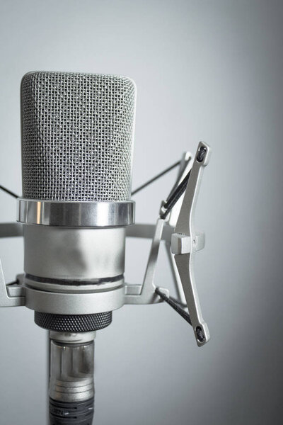 Silver microphone on white background