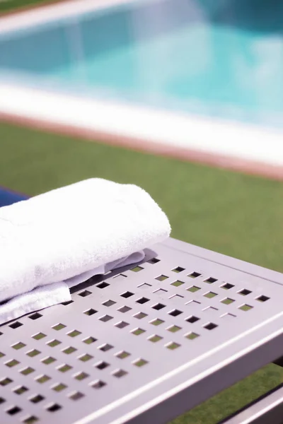 Handdoek op tafel in het zwembad van een luxehotel — Stockfoto