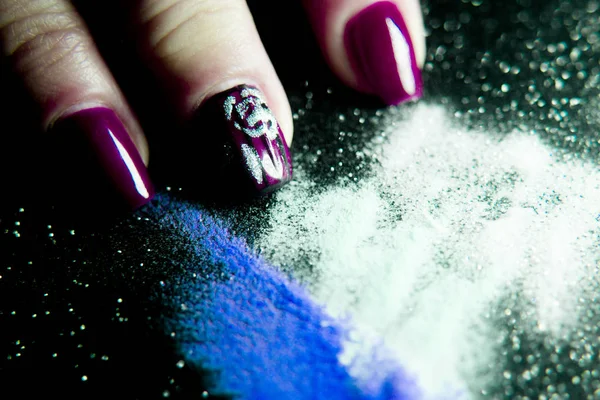 Gel nails next to acrylic powder to make them