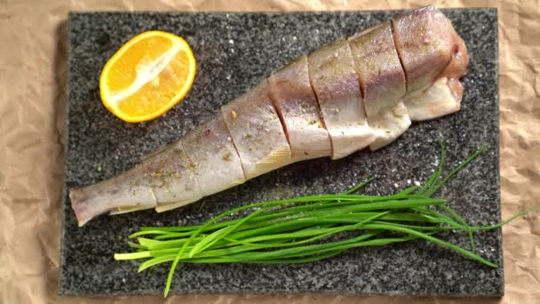 Cooking. Fish, onions on Board. sprinkle with salt — ストック動画