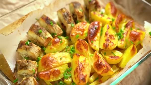 Baked fish and potatoes sprinkle with green onions — Stok video