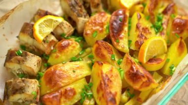 Cooking. Baked fish and potatoes, put a lemon.
