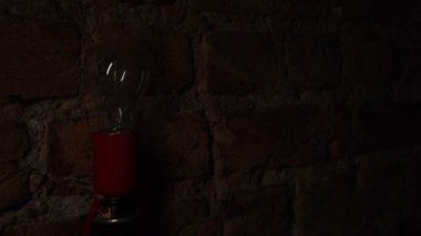 Lit the lamp on brick wall background