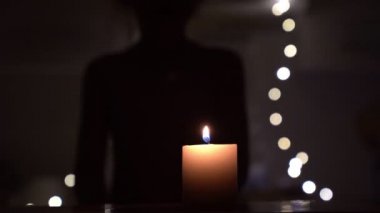 A candle lit the lighter, and the little girl is blonde it blows.