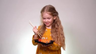 girl drops the roll, learning to hold sticks.
