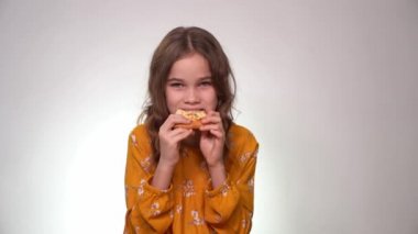 teen girl biting and eating pizza. Fast food.