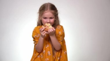 The little girl eating the pizza and laughing.