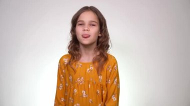 Girl teenage girl shows tongue, looking at camera