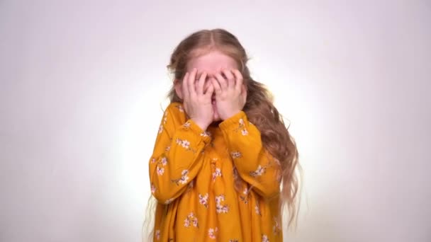 Frightened, little girl is afraid and hides face — Wideo stockowe