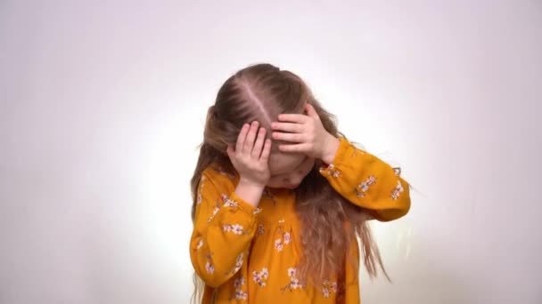 Headache little girl with blond hair, yellow dress — 图库视频影像