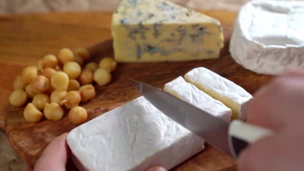 On wooden Board Camembert cheese cut with a knife — Stock videók