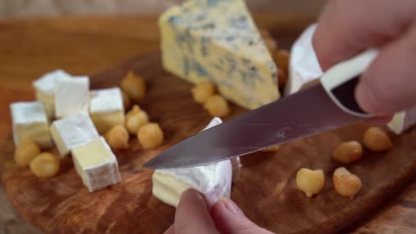 Sobre tabla de madera triángulo corte brie cuchillo de queso — Vídeo de stock