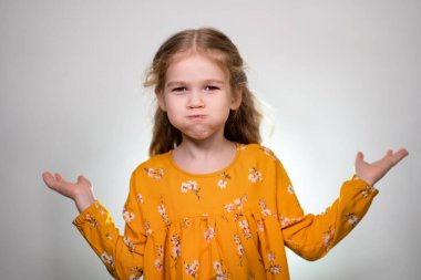 A little girl puffs out her cheeks