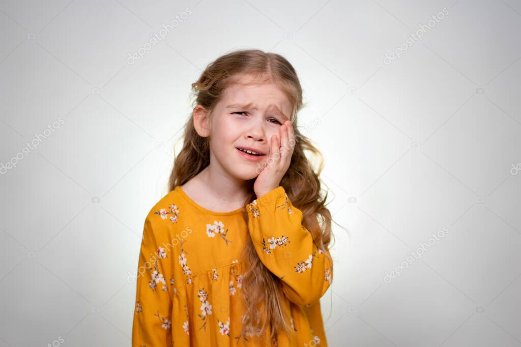 Strong Toothache little girl with long blonde hair