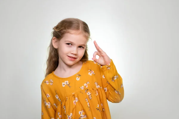 Finger glasses make a little girl blonde funny — Stockfoto