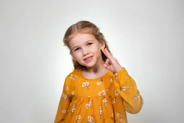 Finger glasses make a little girl blonde funny — Stockfoto