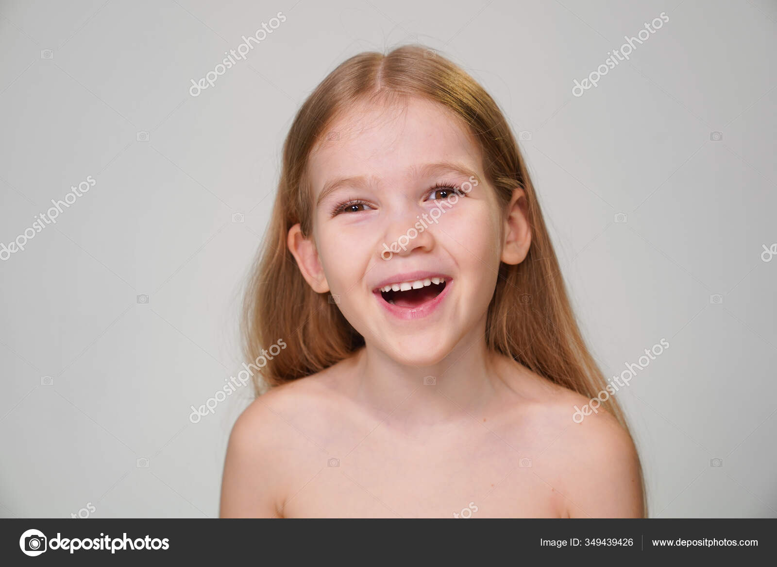 Portrait of caucasian teen girl, isolated on white background. Beautiful  young teenager smiling with wind in her hair. Happy cute child laughing.  Stock Photo
