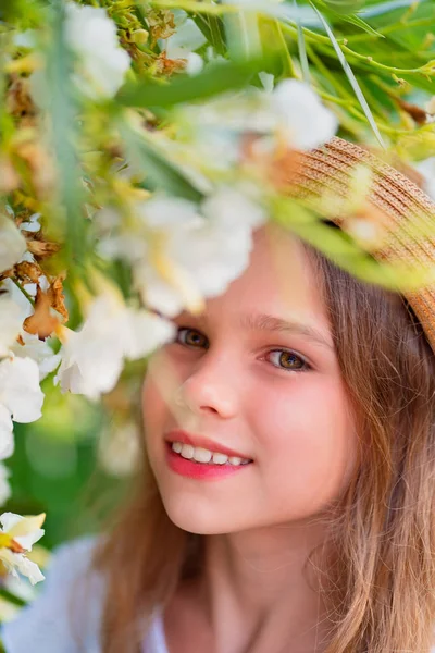 Portrait of blonde girl among white flowers — Stock Photo, Image