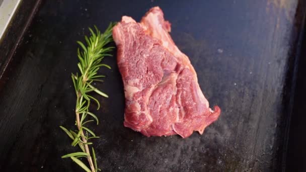 On stove, roasting piece meat and sprig rosemary — Αρχείο Βίντεο