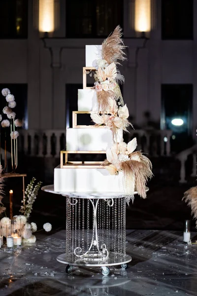 white square tiered wedding cake with feathers.
