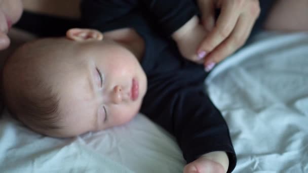 Close-up. mom and baby in black sleeping together — Stock video