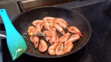 smoke. pan fried shrimp. kitchen of restaurant.