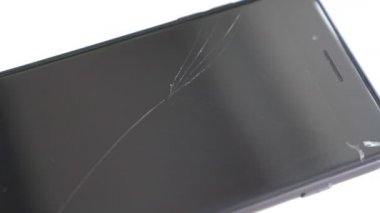 broken safety glass on the black phone.