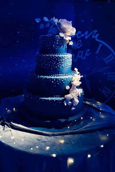 Mörkblå flerskiktad bröllopstårta i mörker — Stockfoto