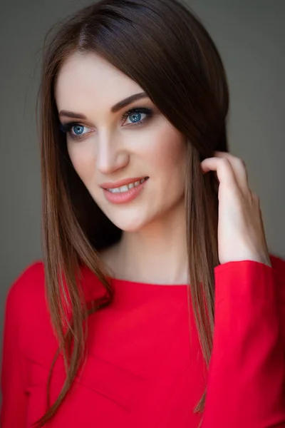 Retrato menina bonita em vermelho corrige o cabelo — Fotografia de Stock