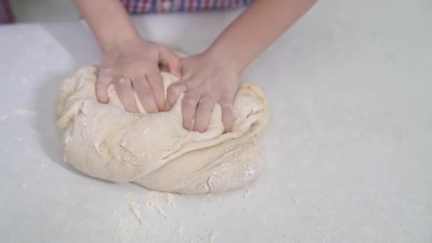 Kid hands knead yeast dough for pizza or pie — Stock Video