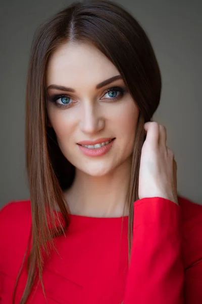 Retrato menina bonita em vermelho corrige o cabelo — Fotografia de Stock