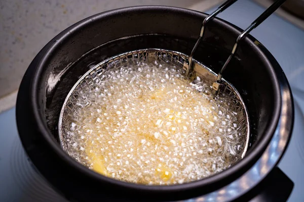 French fries. oil boiling in a deep fryer at home.