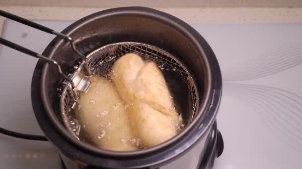 In mini deep fryer for home cook sausage rolls — Stock Video