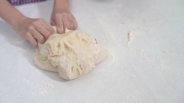 Kid hands study knead yeast dough for pizza or pie — Stock Video