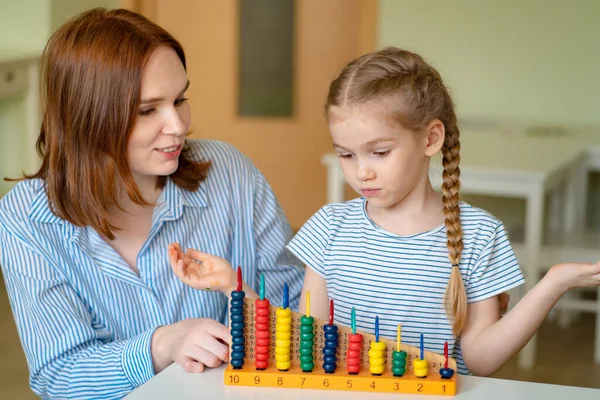mom with girl learning to add and subtract
