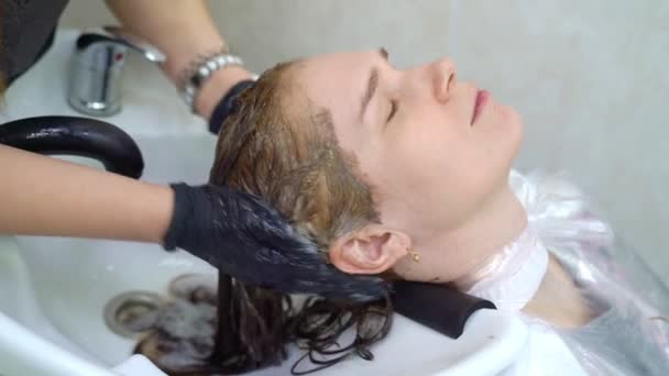 Shampoo na haarkleuring. handen in handschoenen. — Stockvideo