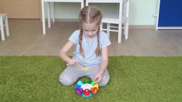 Girl play with whirligig colourful musical bells — Stock Video