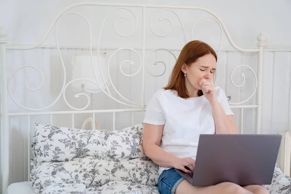 Kobieta kaszel łóżka i pracy w komputerze pobyt w domu — Zdjęcie stockowe