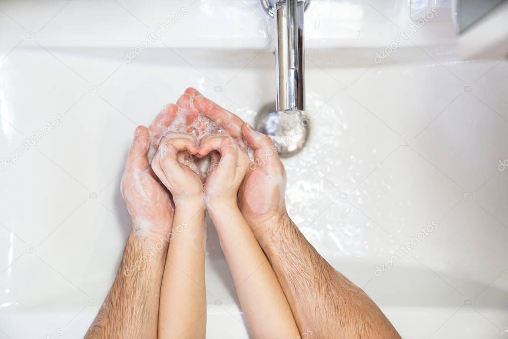 heart. dad teaches daughter thorough washing hands