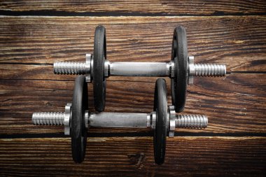 Ahşap arka planda katlanabilir dambıllar